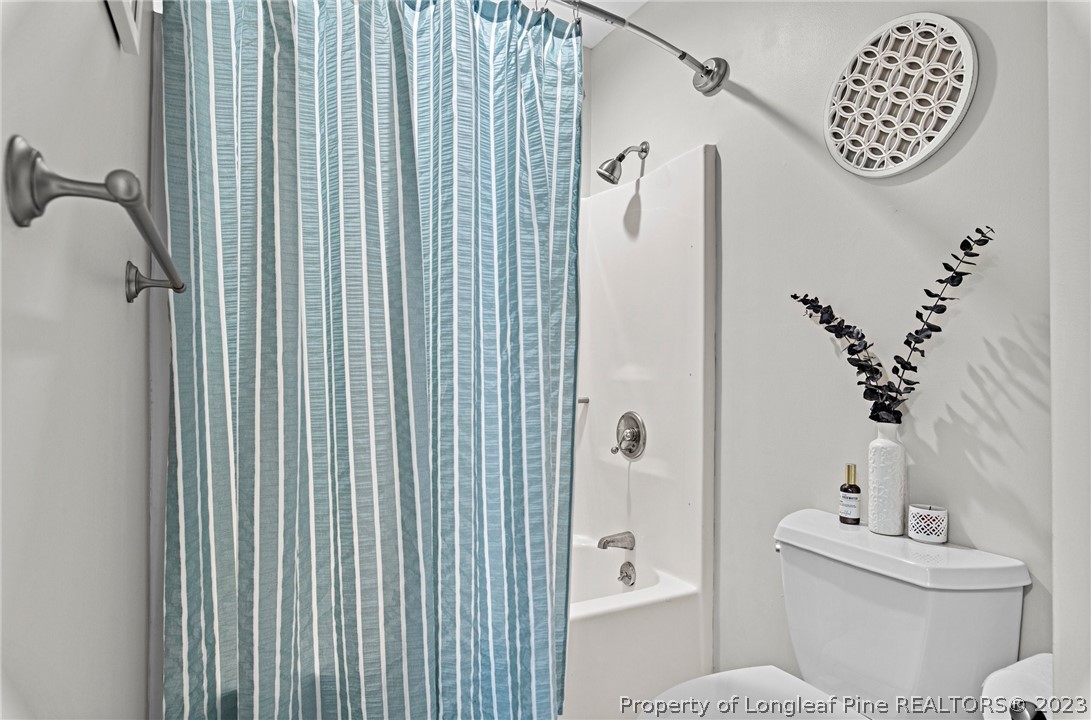 269 Knoll Road, Unit 409 Southern Pines, NC 28387 - Photo 22 of 40 a white toilet sitting next to a bathroom sink