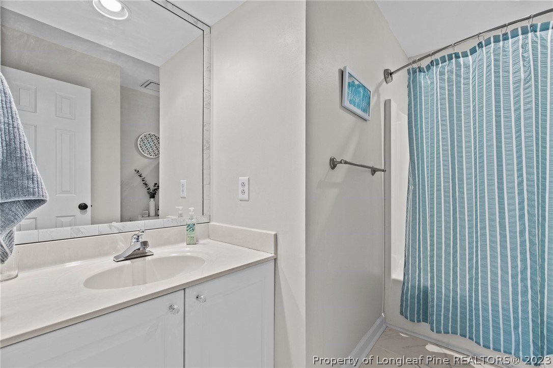 269 Knoll Road, Unit 409 Southern Pines, NC 28387 - Photo 23 of 40 a bathroom with a sink and a mirror
