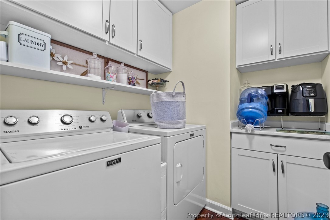 269 Knoll Road, Unit 409 Southern Pines, NC 28387 - Photo 28 of 40 a kitchen with a stove and white cabinets