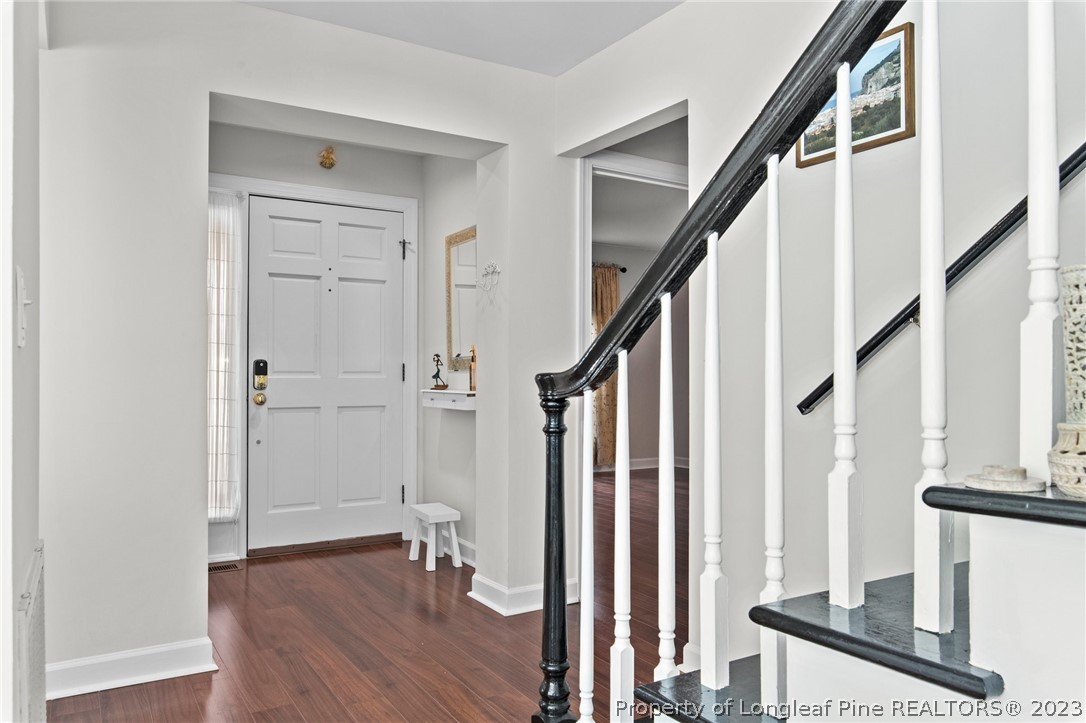 269 Knoll Road, Unit 409 Southern Pines, NC 28387 - Photo 4 of 40 a view of an entryway with wooden floor and staircase
