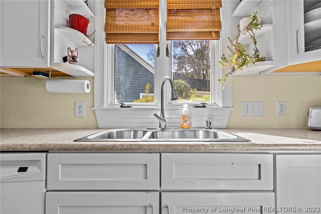 269 Knoll Road, Unit 409 Southern Pines, NC 28387 - Photo 7 of 40 a kitchen with a sink cabinets and a window