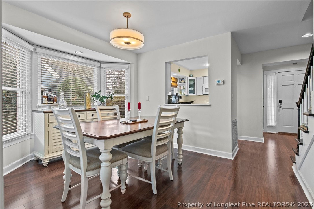 269 Knoll Road, Unit 409 Southern Pines, NC 28387 - Photo 10 of 40 a view of a dining room with furniture and wooden floor