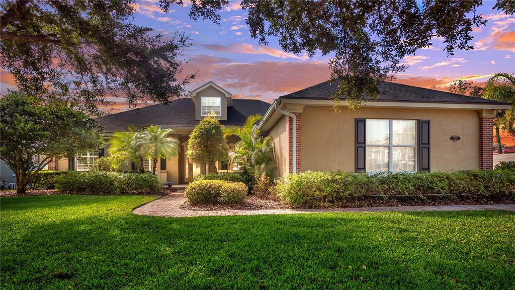 a front view of house with yard and green space