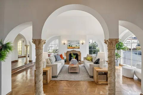 a living room with a couch and a potted plant