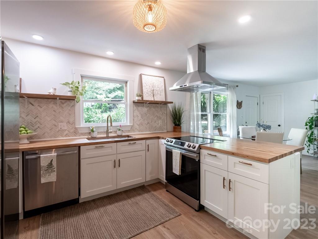 39 Cedar Mountain Road Asheville, NC 28803 - Photo 15 of 35 a kitchen with stainless steel appliances granite countertop a sink and stove
