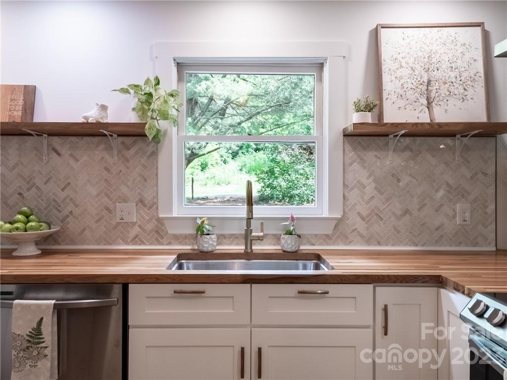 39 Cedar Mountain Road Asheville, NC 28803 - Photo 16 of 35 a sink with granite countertop a window and a sink