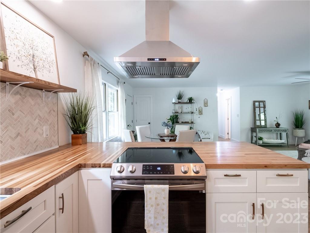 39 Cedar Mountain Road Asheville, NC 28803 - Photo 17 of 35 a kitchen with a stove and cabinets