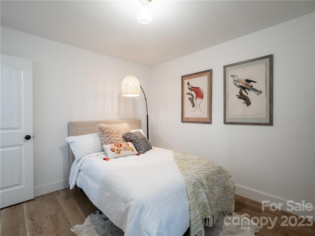39 Cedar Mountain Road Asheville, NC 28803 - Photo 20 of 35 a bedroom with a bed and a painting on the wall