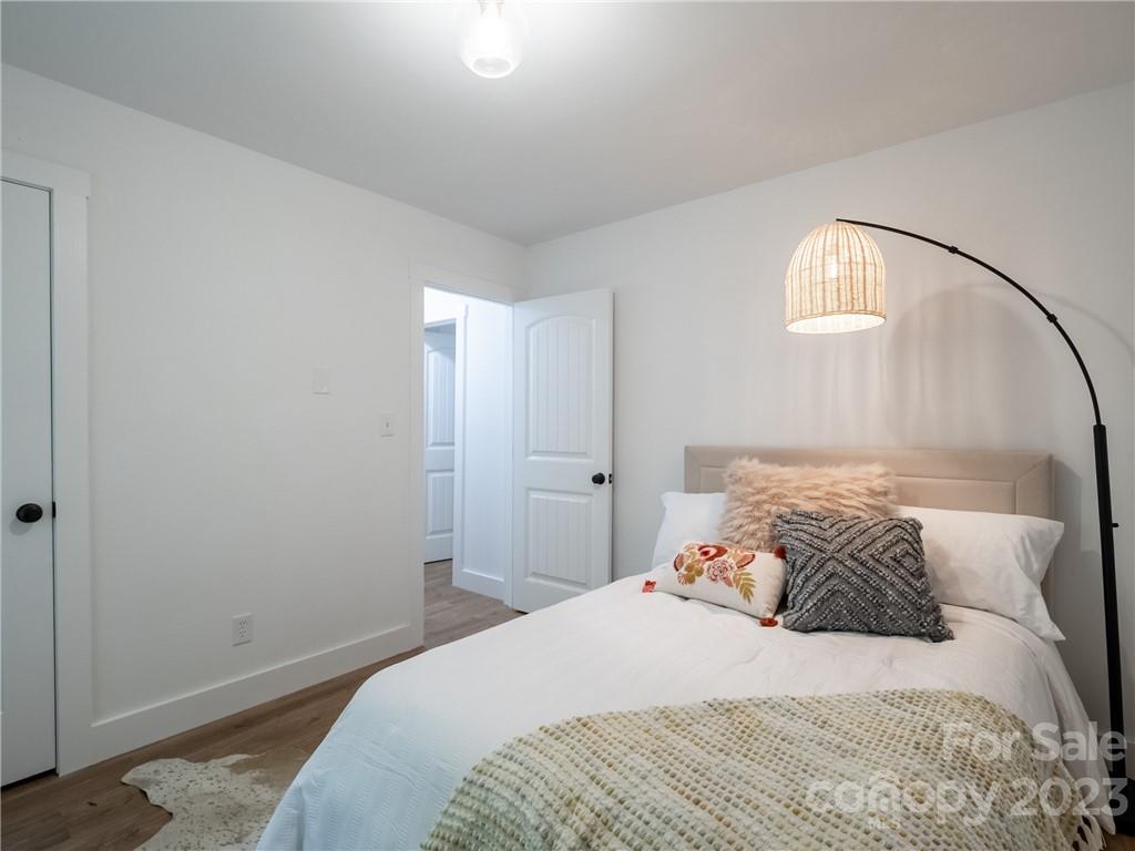 39 Cedar Mountain Road Asheville, NC 28803 - Photo 21 of 35 a bedroom with a bed and a mirror