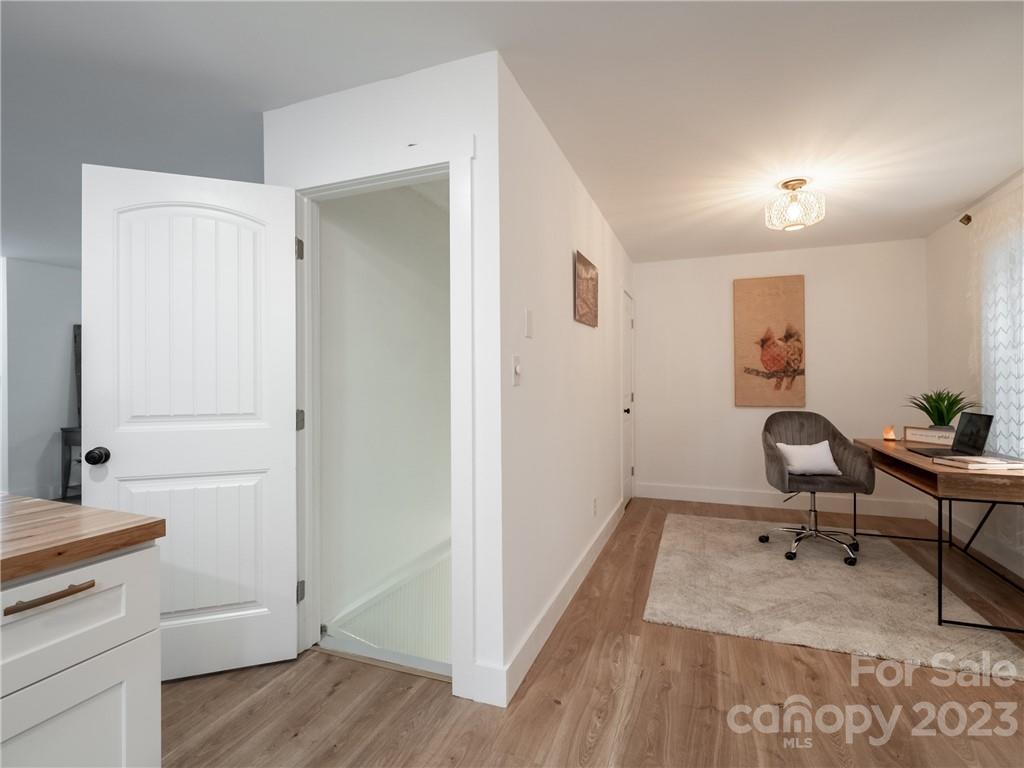 39 Cedar Mountain Road Asheville, NC 28803 - Photo 24 of 35 a workspace with wooden floor and furniture