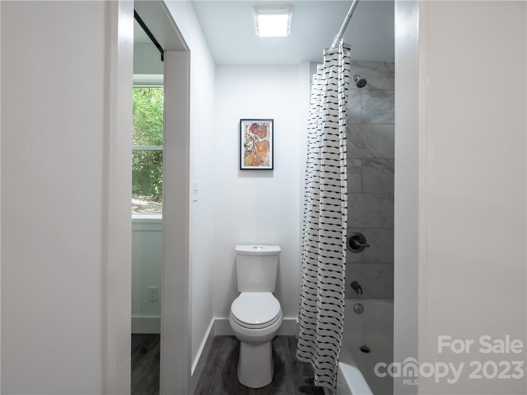 39 Cedar Mountain Road Asheville, NC 28803 - Photo 28 of 35 a bathroom with a toilet and a shower