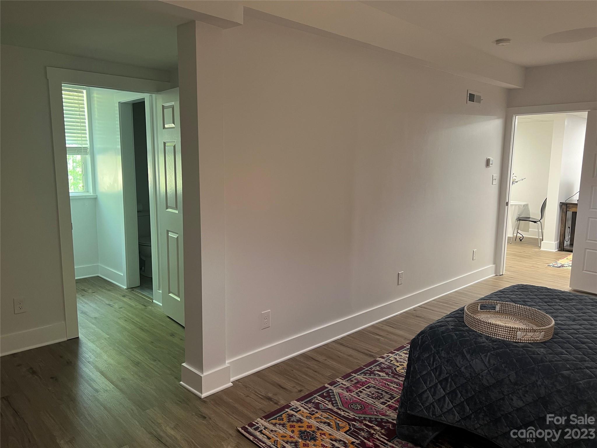 39 Cedar Mountain Road Asheville, NC 28803 - Photo 30 of 35 a bedroom with a bed and a mirror on the dresser