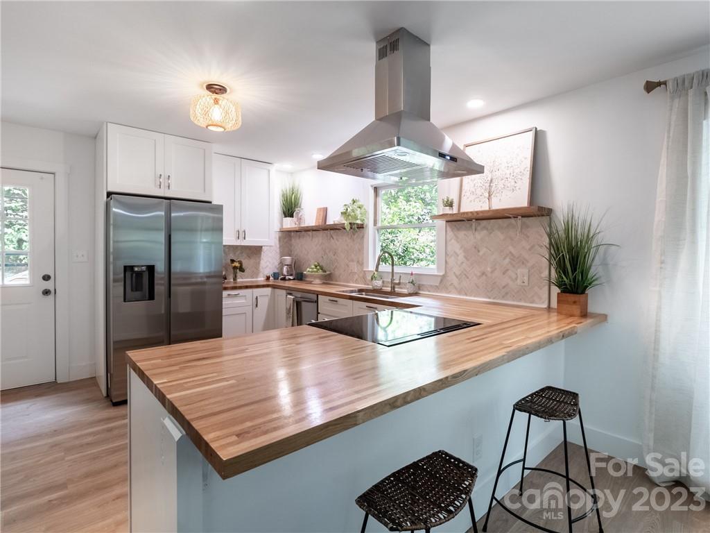 39 Cedar Mountain Road Asheville, NC 28803 - Photo 3 of 35 a kitchen with stainless steel appliances granite countertop a sink a stove and refrigerator