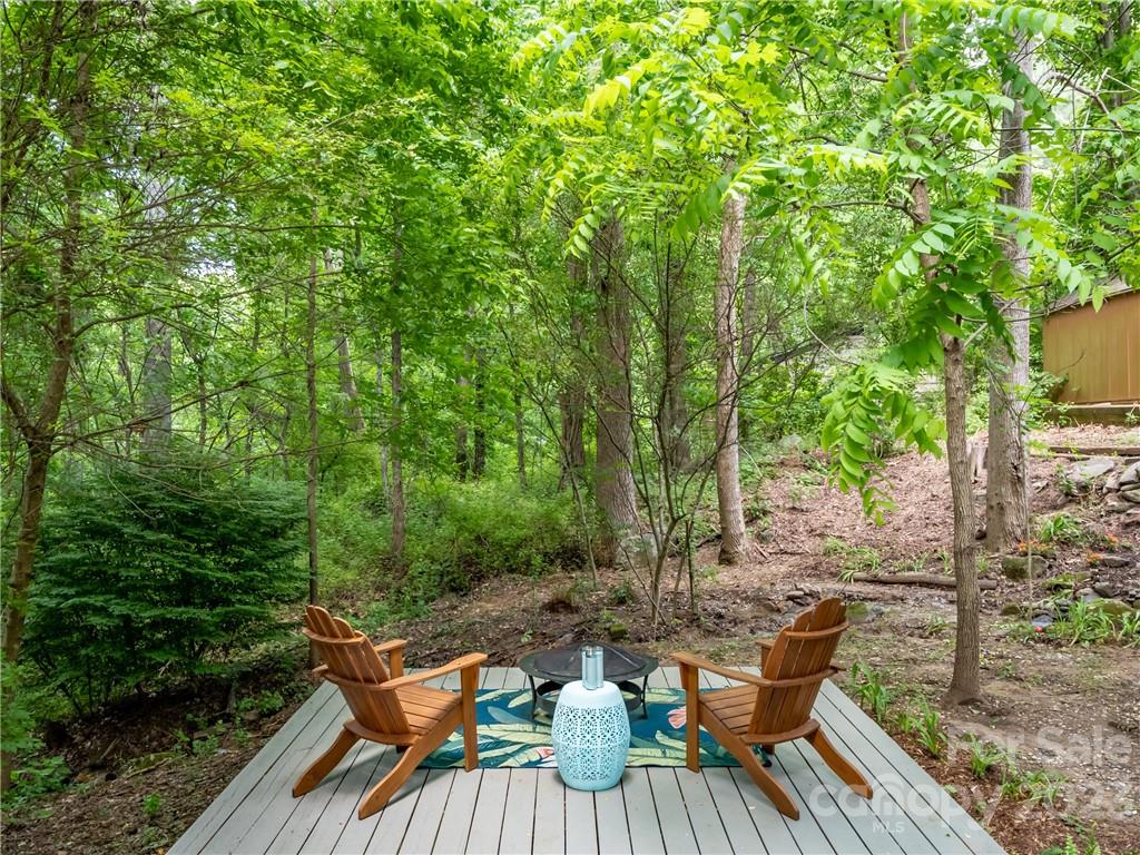 39 Cedar Mountain Road Asheville, NC 28803 - Photo 5 of 35 a view of a table and chairs on the deck