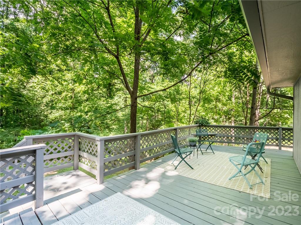39 Cedar Mountain Road Asheville, NC 28803 - Photo 6 of 35 a view of balcony with wooden floor and outdoor seating