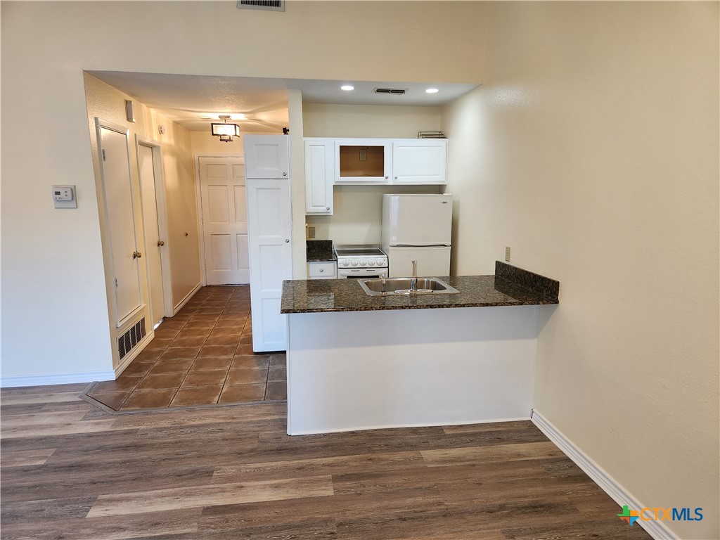 1015 Old Mill Road, Unit 4A Salado, TX 76571 - Photo 11 of 17 a view of kitchen with wooden floor