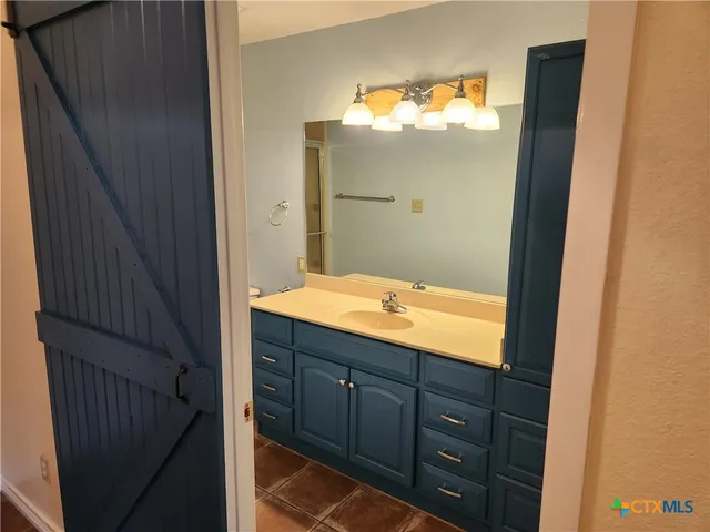 a bathroom with a sink and mirror