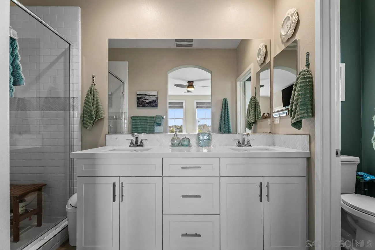 4326 Star Path Way, Unit 1 Oceanside, CA 92056 - Photo 29 of 46 a bathroom with a double vanity sink and a mirror
