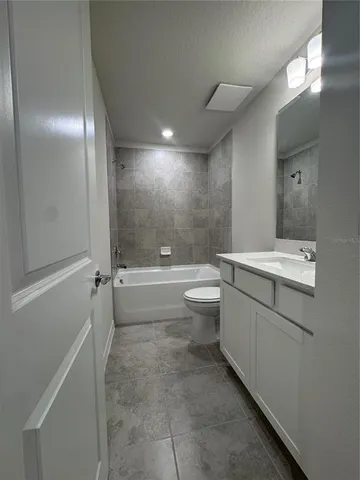 a bathroom with a double vanity sink toilet and shower