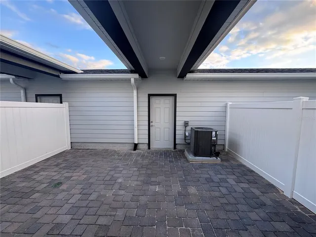a view of a livingroom with a refrigerator and a fireplace