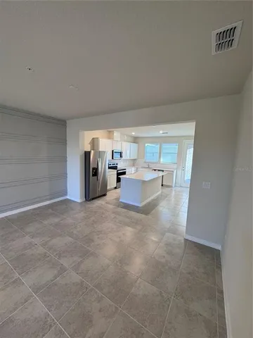 a living room with furniture and white walls
