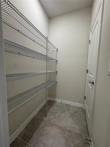 a view of storage and utility room with empty racks