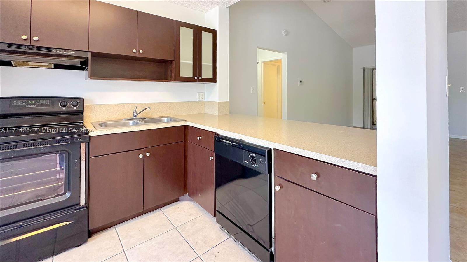 2218 Southwest 81st Avenue, Unit 2218 Miramar, FL 33025 - Photo 16 of 16 a kitchen with a sink and cabinets
