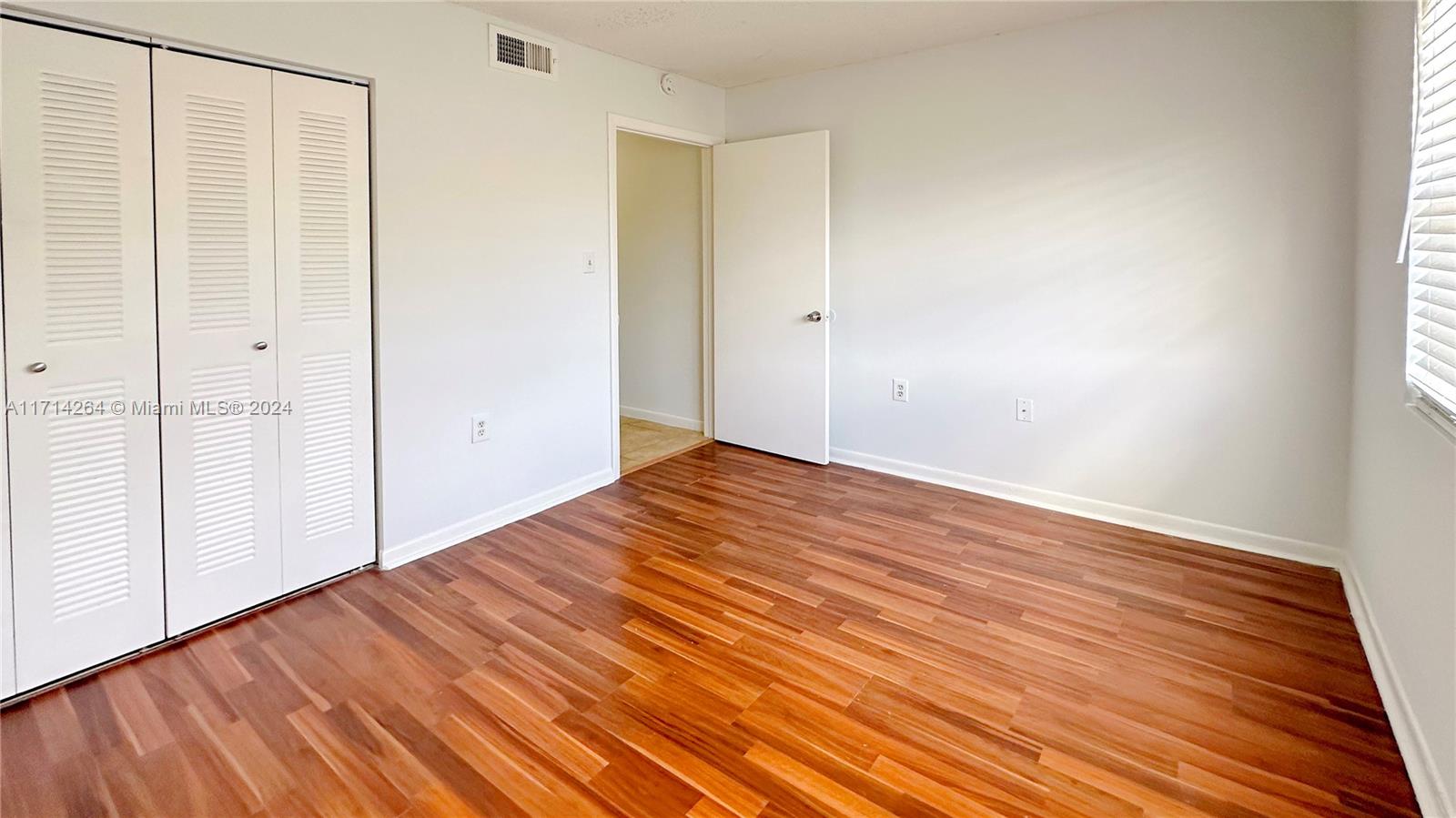2218 Southwest 81st Avenue, Unit 2218 Miramar, FL 33025 - Photo 4 of 16 a view of a room with wooden floor and bench