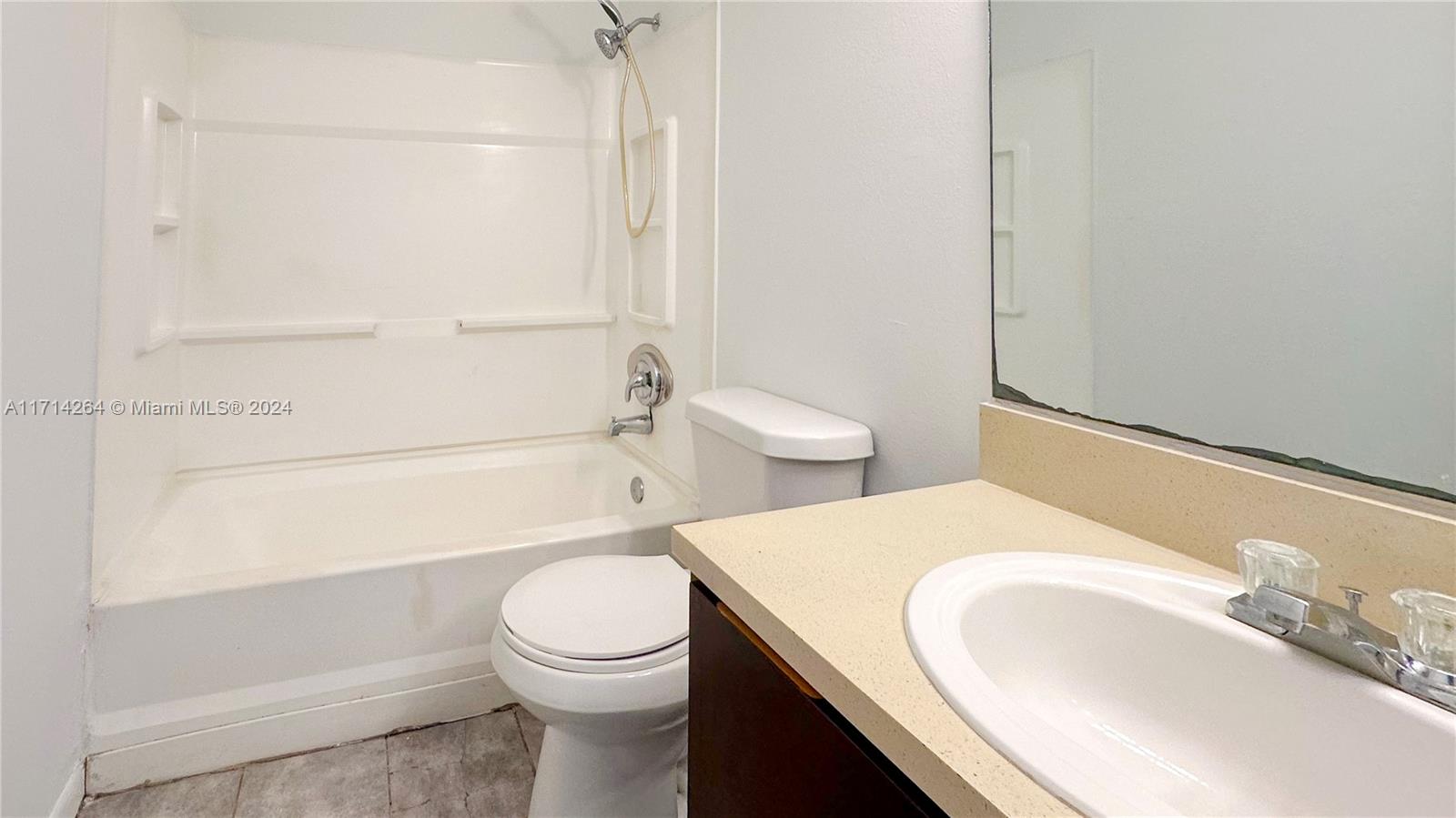 2218 Southwest 81st Avenue, Unit 2218 Miramar, FL 33025 - Photo 7 of 16 a bathroom with a sink a toilet and shower