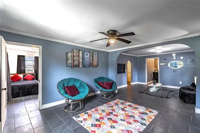 a living room with furniture a rug and a chandelier
