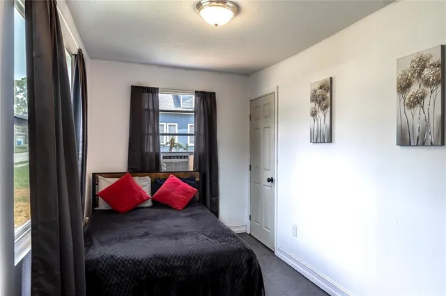 a bedroom with a bed and window