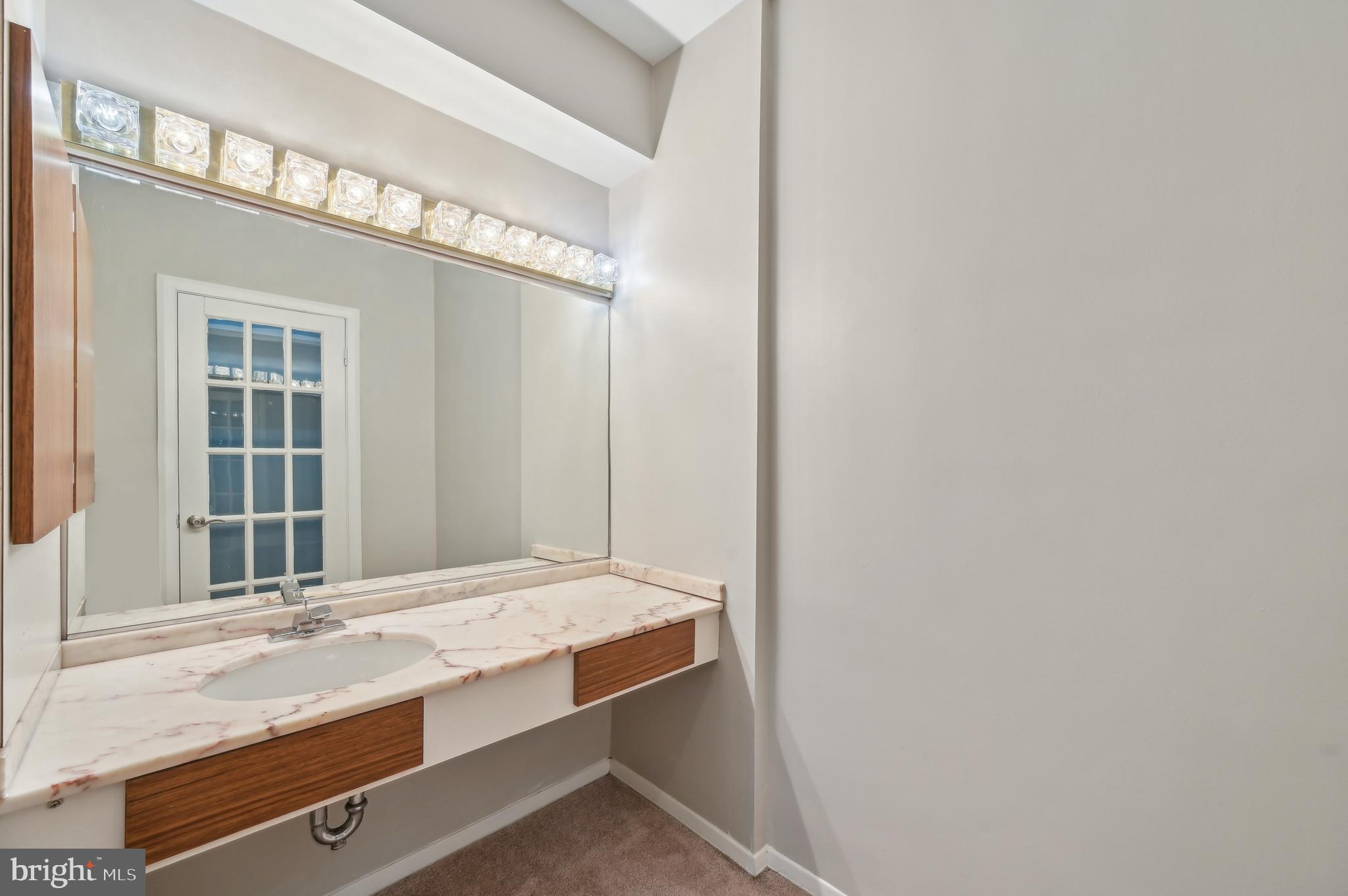 3601 Clarks Lane, Unit 424 Baltimore, MD 21215 - Photo 30 of 38 Vanity in Primary Bedroom