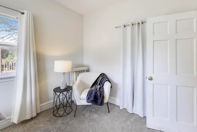a view of a livingroom with furniture and a window