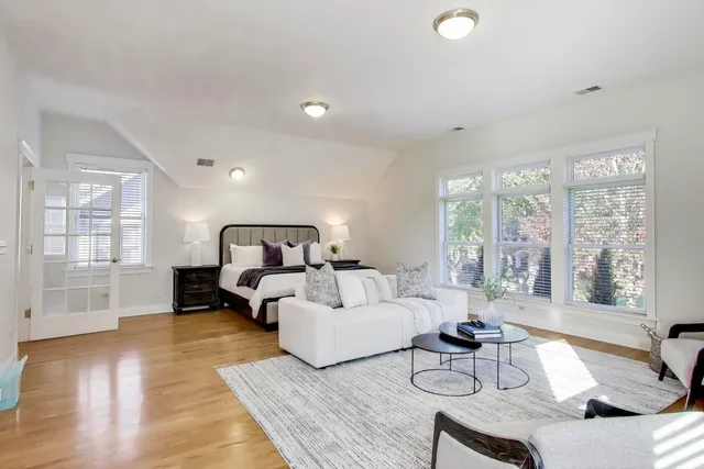 a bedroom with a bed and wooden floor