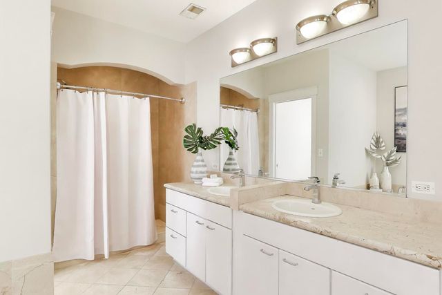 a bath tub sitting next to a white sink
