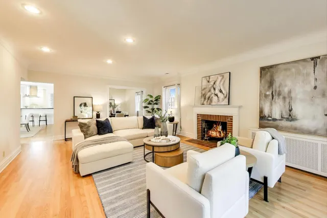 a living room with fireplace furniture and a fireplace