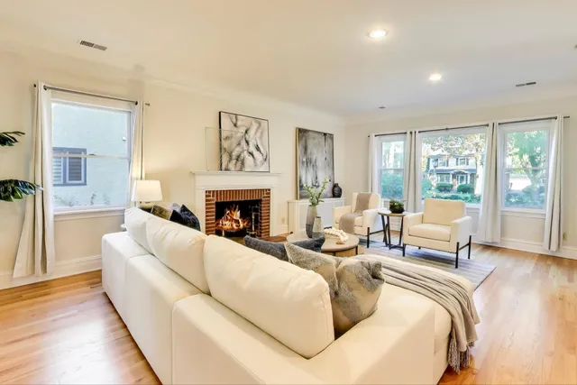 a living room with furniture and a fireplace