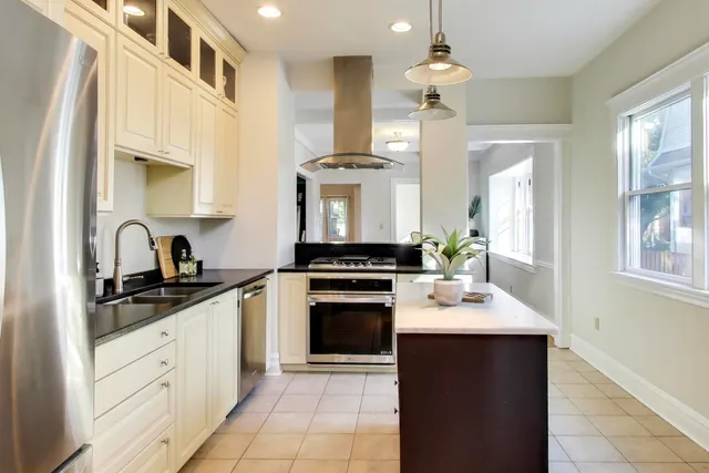a kitchen with a sink stove and refrigerator