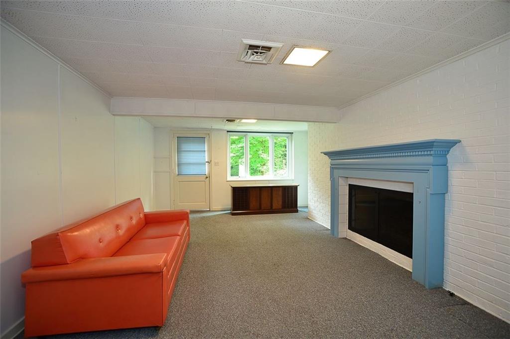 9600 Sheraton Road Pittsburgh, PA 15237 - Photo 13 of 15 Lower level family room with fireplace and walk out door to the rear yard.