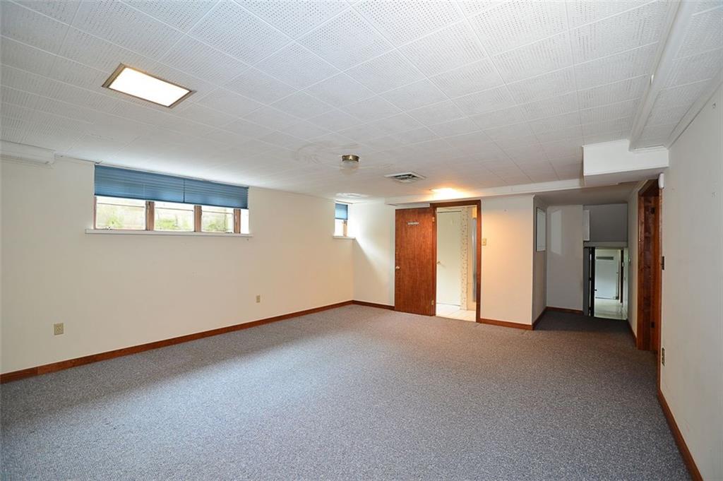 9600 Sheraton Road Pittsburgh, PA 15237 - Photo 14 of 15 Additional lower level room with 3rd full bath, could be large game room or 4th bedroom! Adjacent 17x15 unfinished storage area. Separate laundry room down the hall.