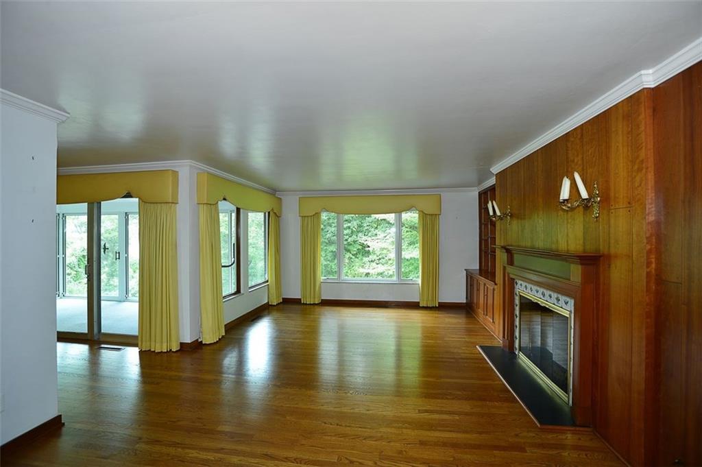 9600 Sheraton Road Pittsburgh, PA 15237 - Photo 4 of 15 Living room with fireplace, built in's, hardwood floors and picture window. Newer top of the line Pella windows!