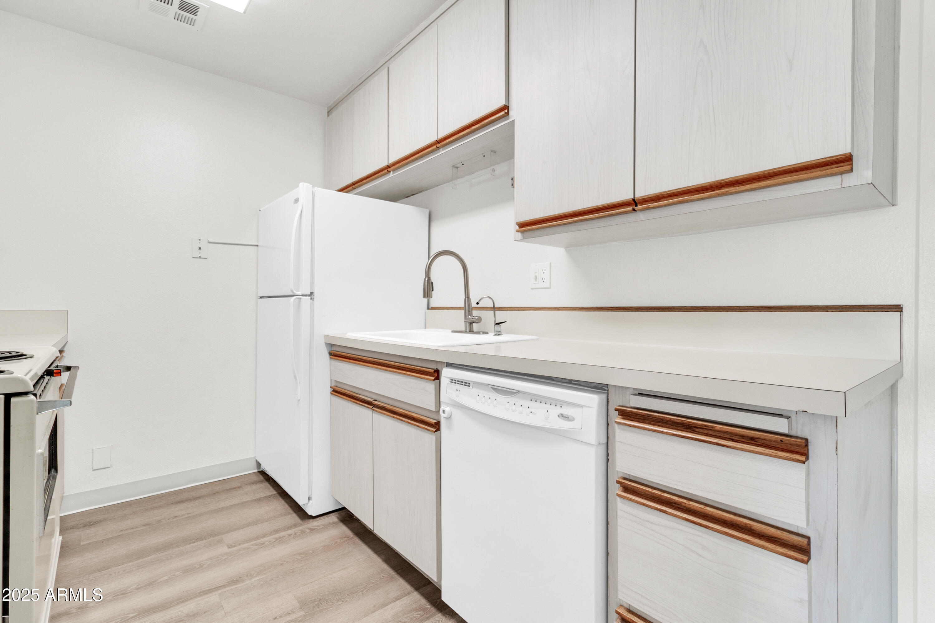 5525 East Thomas Road, Unit F9 Phoenix, AZ 85018 - Photo 22 of 48 a kitchen with a sink cabinets and wooden floor