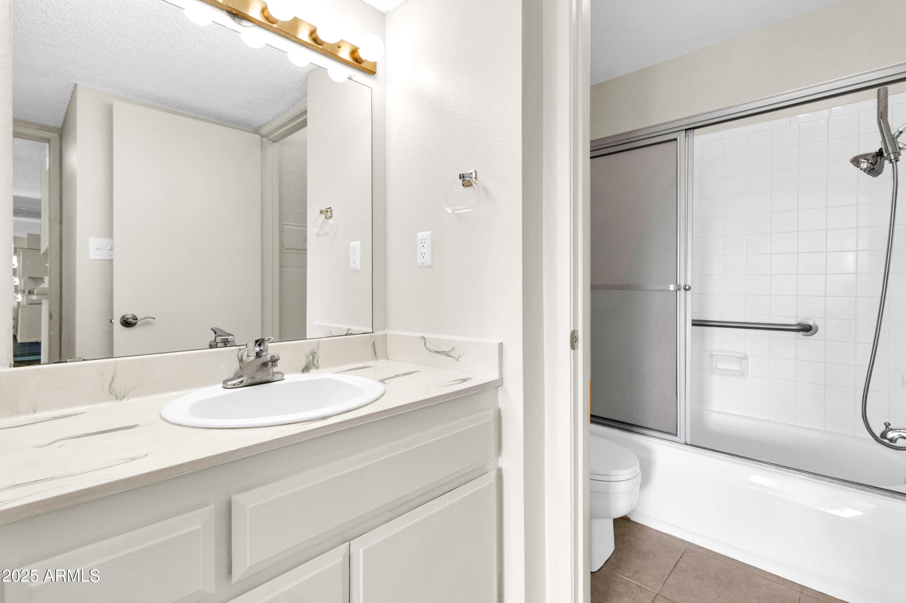 5525 East Thomas Road, Unit F9 Phoenix, AZ 85018 - Photo 35 of 48 a bathroom with a sink and a mirror