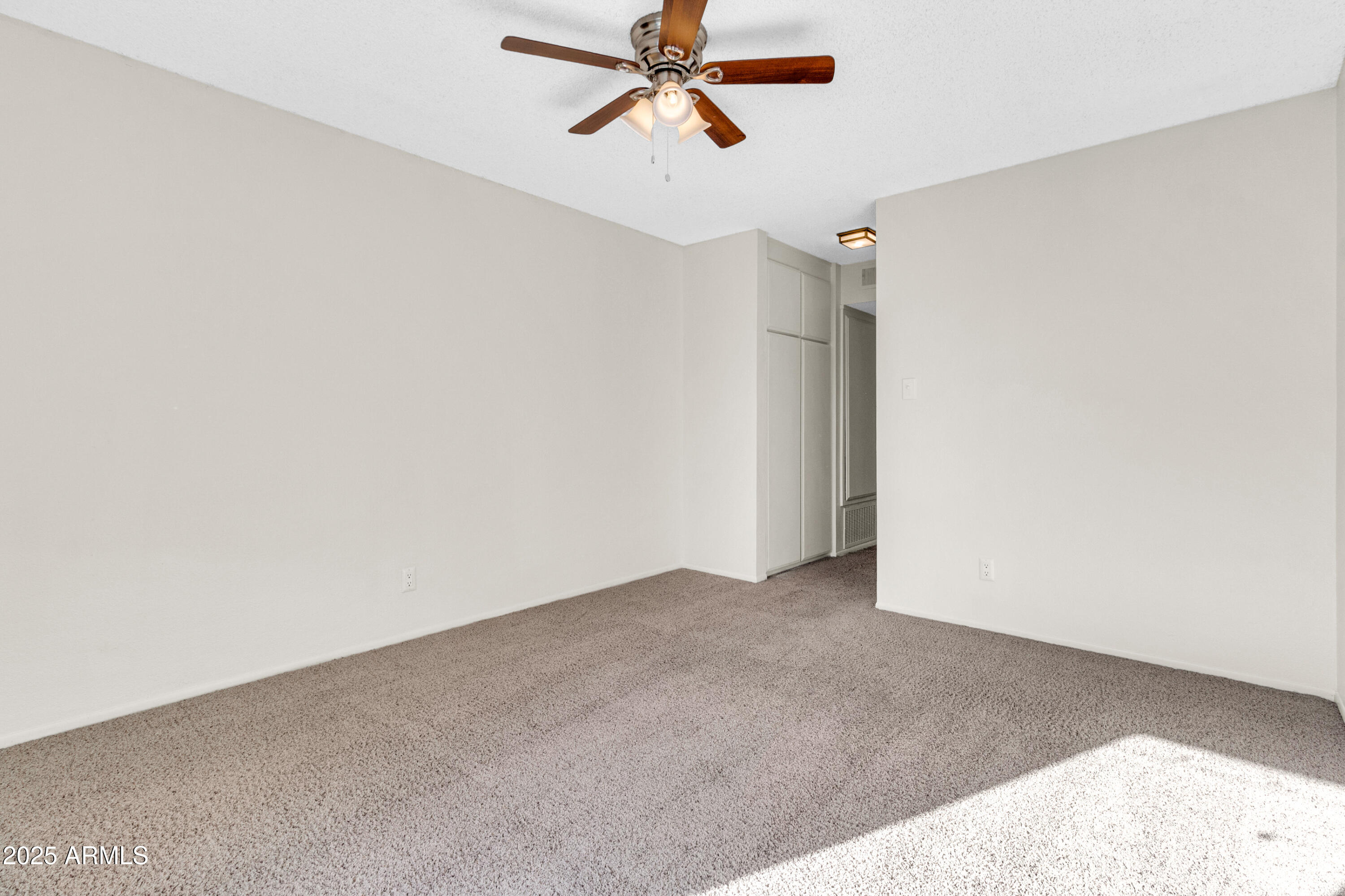 5525 East Thomas Road, Unit F9 Phoenix, AZ 85018 - Photo 37 of 48 an empty room with closet and fan