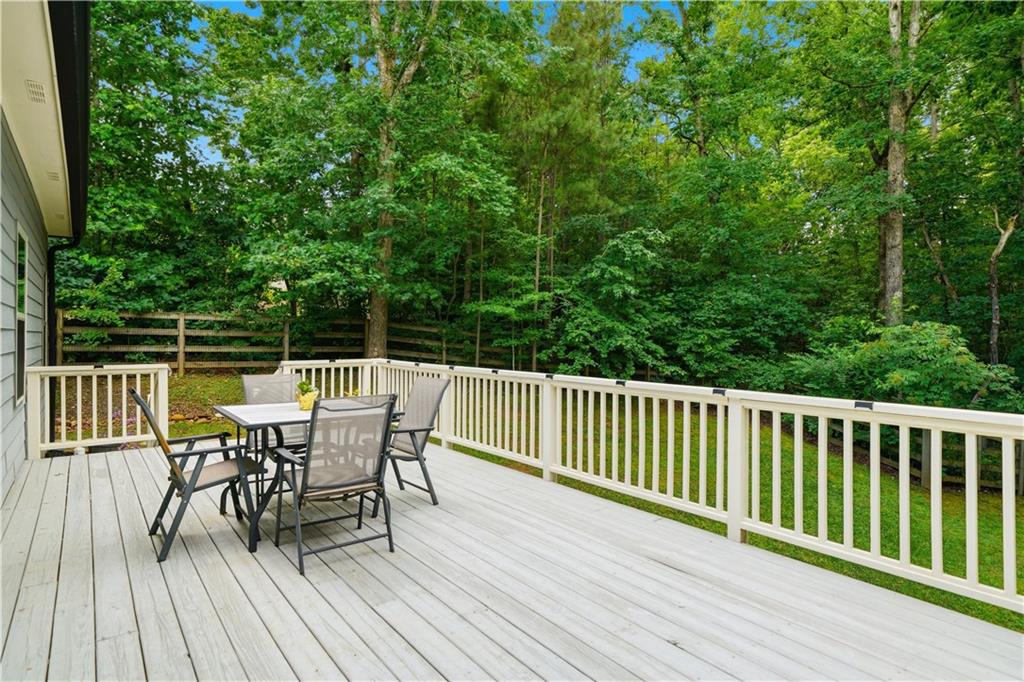 302 Spence Circle Ball Ground, GA 30107 - Photo 35 of 55 a view of a deck with table and chairs and wooden floor
