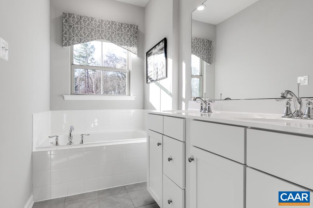 1121 Sunset Ave Extension Charlottesville, VA 22903 - Photo 9 of 20 a bathroom with a double vanity sink window and a large mirror