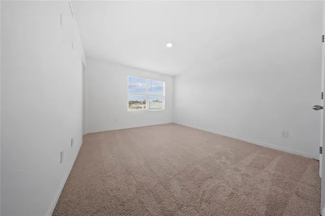 a spacious bathroom with a glass shower door and a sink