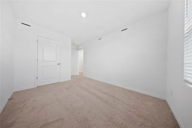 a view of a house with a yard and potted plants