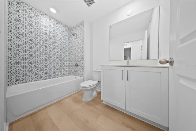 a kitchen with stainless steel appliances a refrigerator stove and microwave