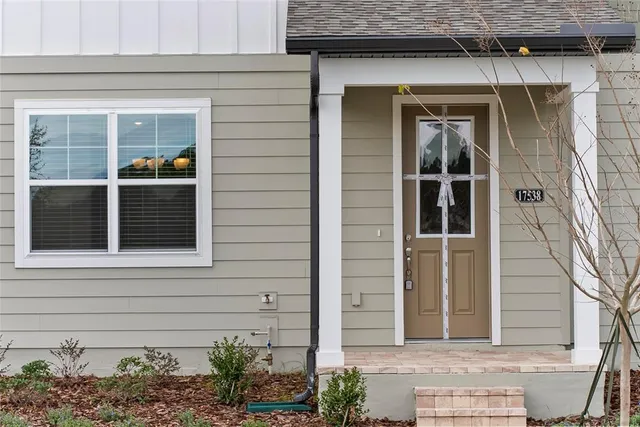 a front view of a house with a lake view and a garden